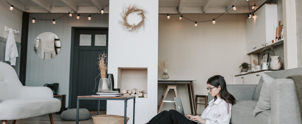 woman sitting on the floor using a laptop