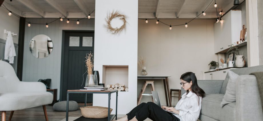 woman sitting on the floor using a laptop