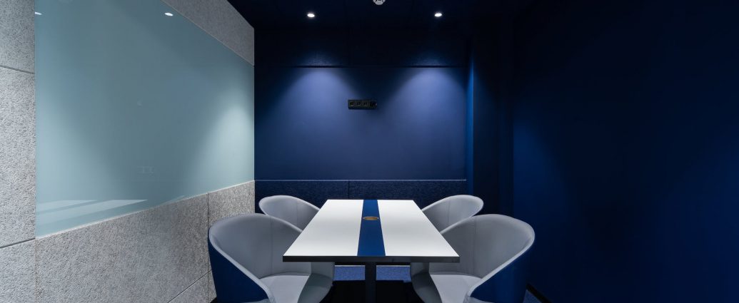 contemporary workspace with blue seats and table