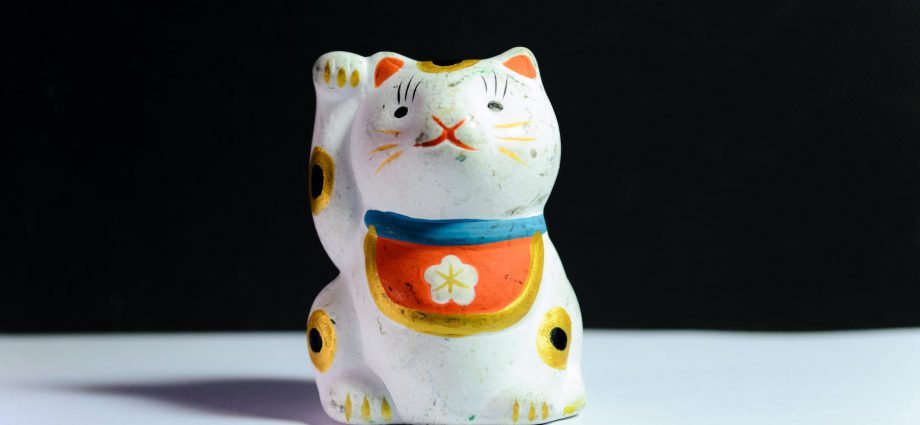 maneki neko figurine on white surface