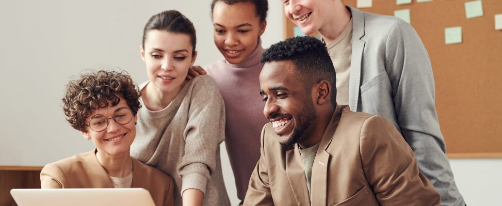 photo of people looking on laptop