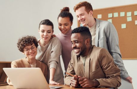 photo of people looking on laptop