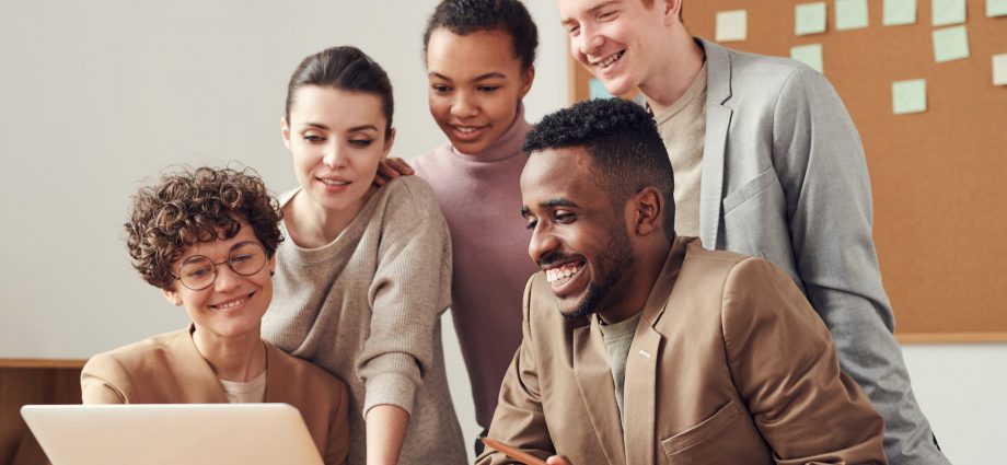 photo of people looking on laptop