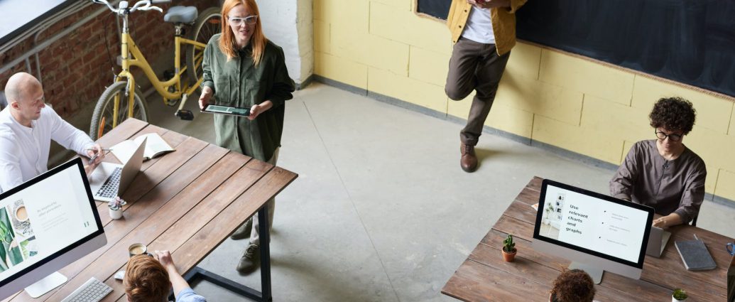 man in brown jacket leaning on black board
