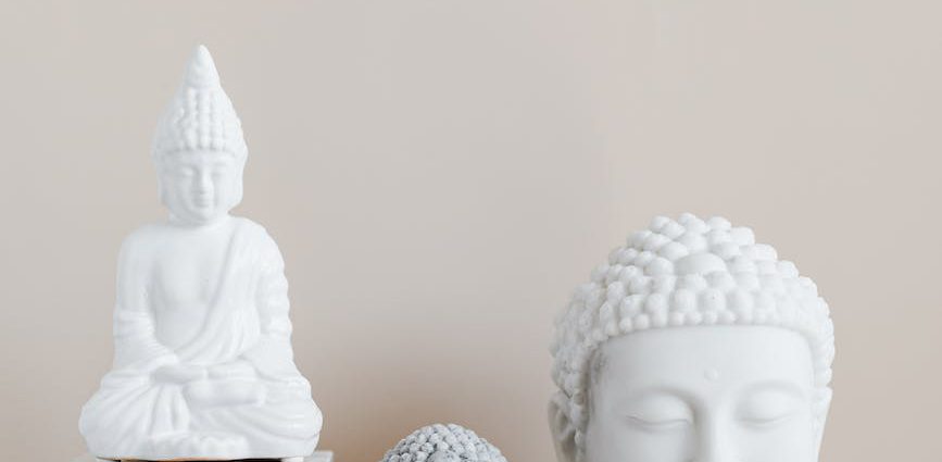 composition of buddha statues on marble stand
