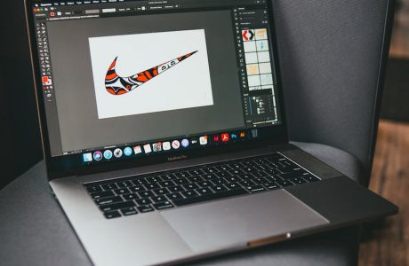 open laptop placed on gray sofa