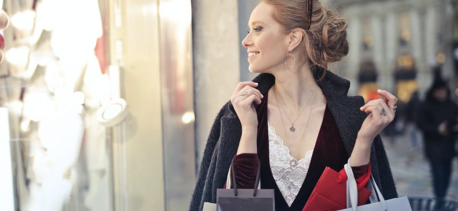 woman wearing black blazer holding shopping bags