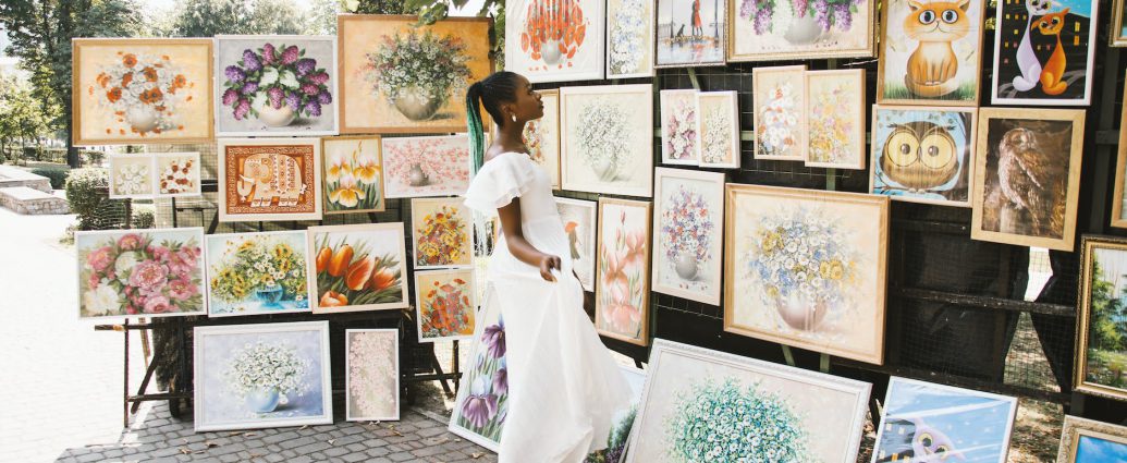 woman looking on flower painting