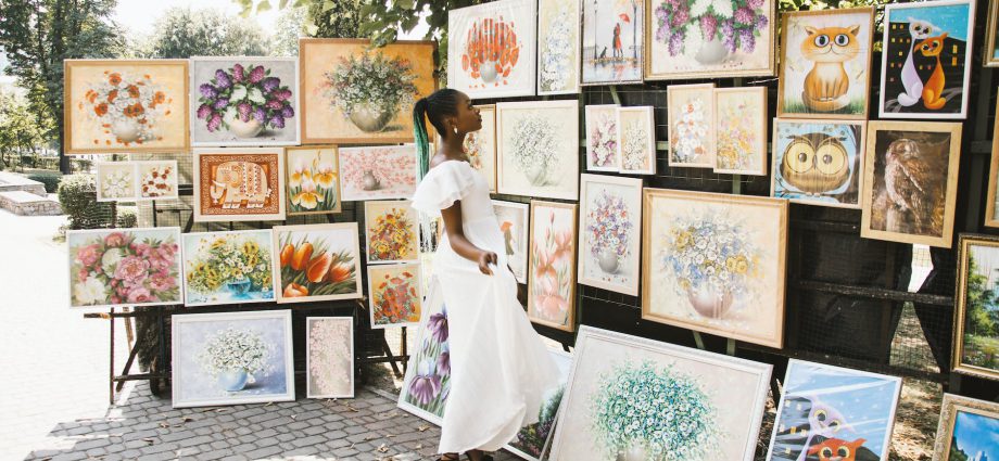 woman looking on flower painting