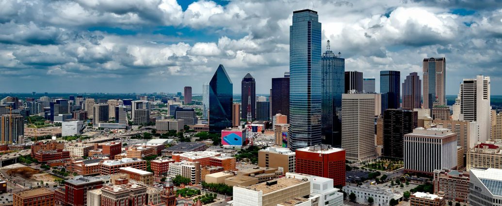 aerial photo of city under white clouds