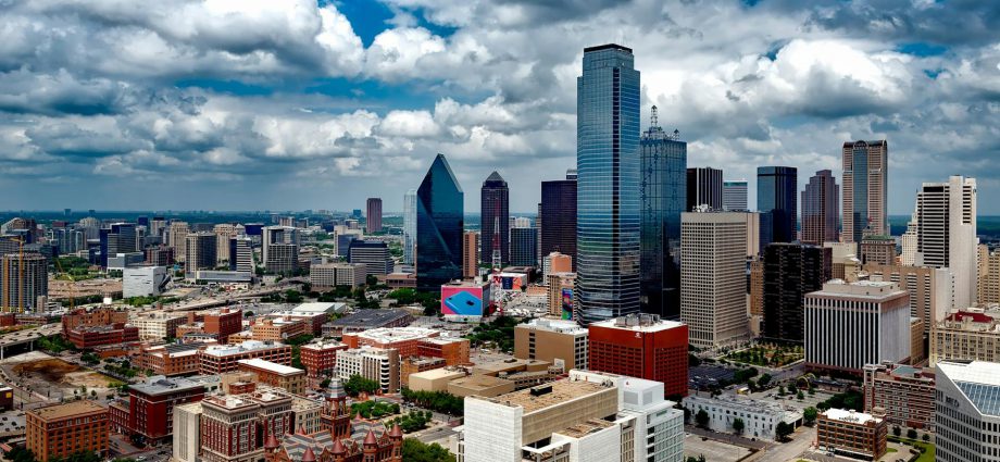 aerial photo of city under white clouds