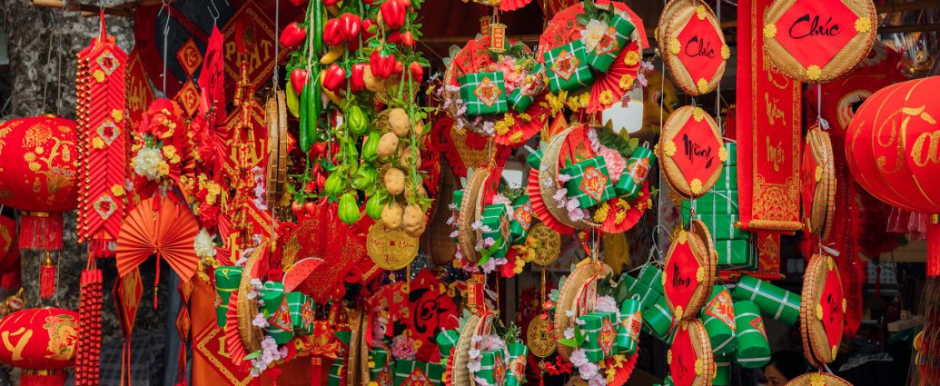 red and green chinese lanterns hanging on the store
